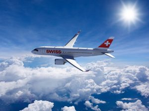 Swiss Airways owned CS100 flying on its first flight commercially from Zurich to London. It is flying above the clouds.