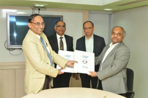 D. K. Venkatesh, Director (Engg. and R&D), HAL (extreme left) and Dr A. T. Kalghatgi, Director (R&D), BEL exchanging the MoU documents in the presence of Mr. T Suvarna Raju, CMD HAL (second from left) and  S. K. Sharma, CMD, BEL