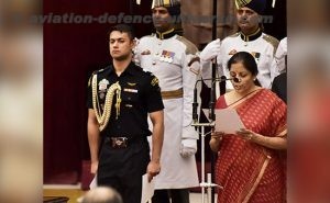 Nirmala Sitharaman taking oath in the Cabinet reshuffle. She is taking oath as Defence Minister. Standing behind is the Staff Officer who is an army officer.