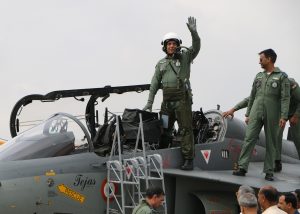 The Union Minister for Defence, Shri Rajnath Singh after his maiden sortie in LCA Tejas with Air Vice Marshal Narmdeshwar Tiwari, at HAL Airport,