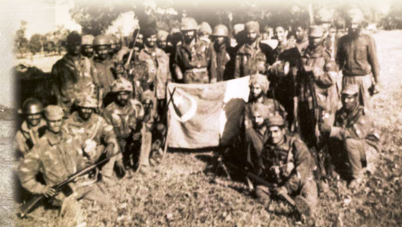 History III- Lt Tejinder Singh and ‘B’ Platoon of 411 Parachute Field Company with a captured Pakistani flag, post Tangail paradrop