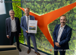 Deutsche Aircraft CEO Nico Neumann (center) holds the signed contract 